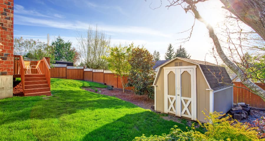 Fenced backyard with storage shed in Stamford